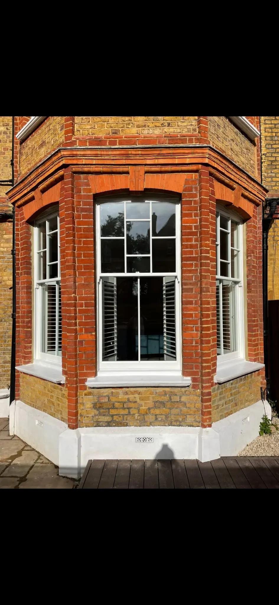 Bespoke timber sash bay windows with historic glazing bar detailing installed in a Victorian brick facade