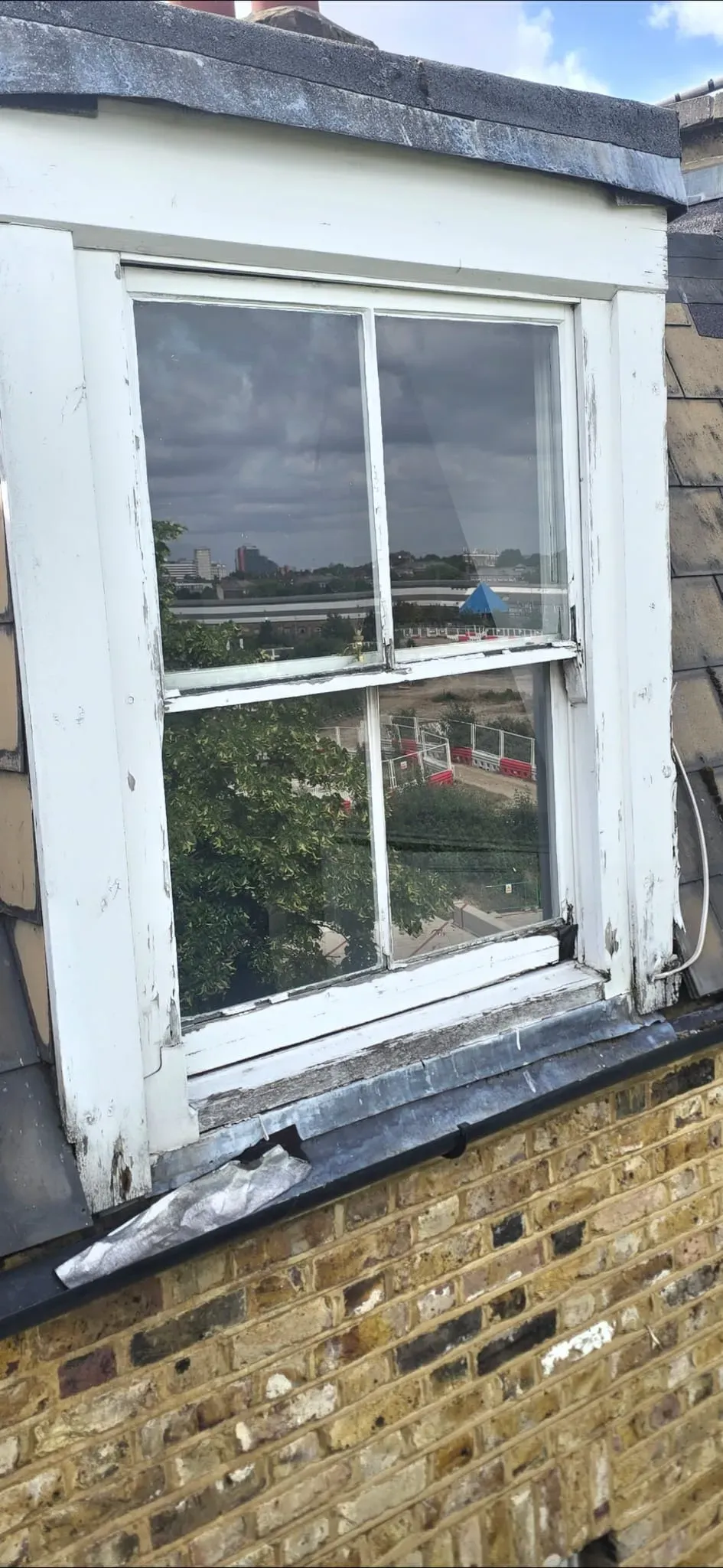 Weathered and rotten timber sash window sill and box frame in need of restoration
